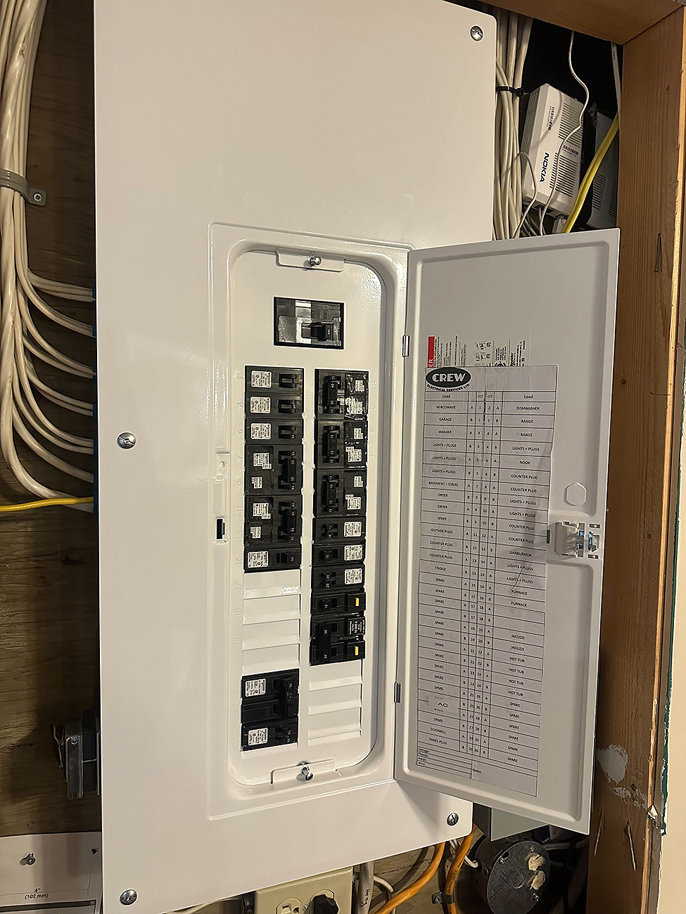Crew Technical Services technician setting up a residential load management system in Calgary.