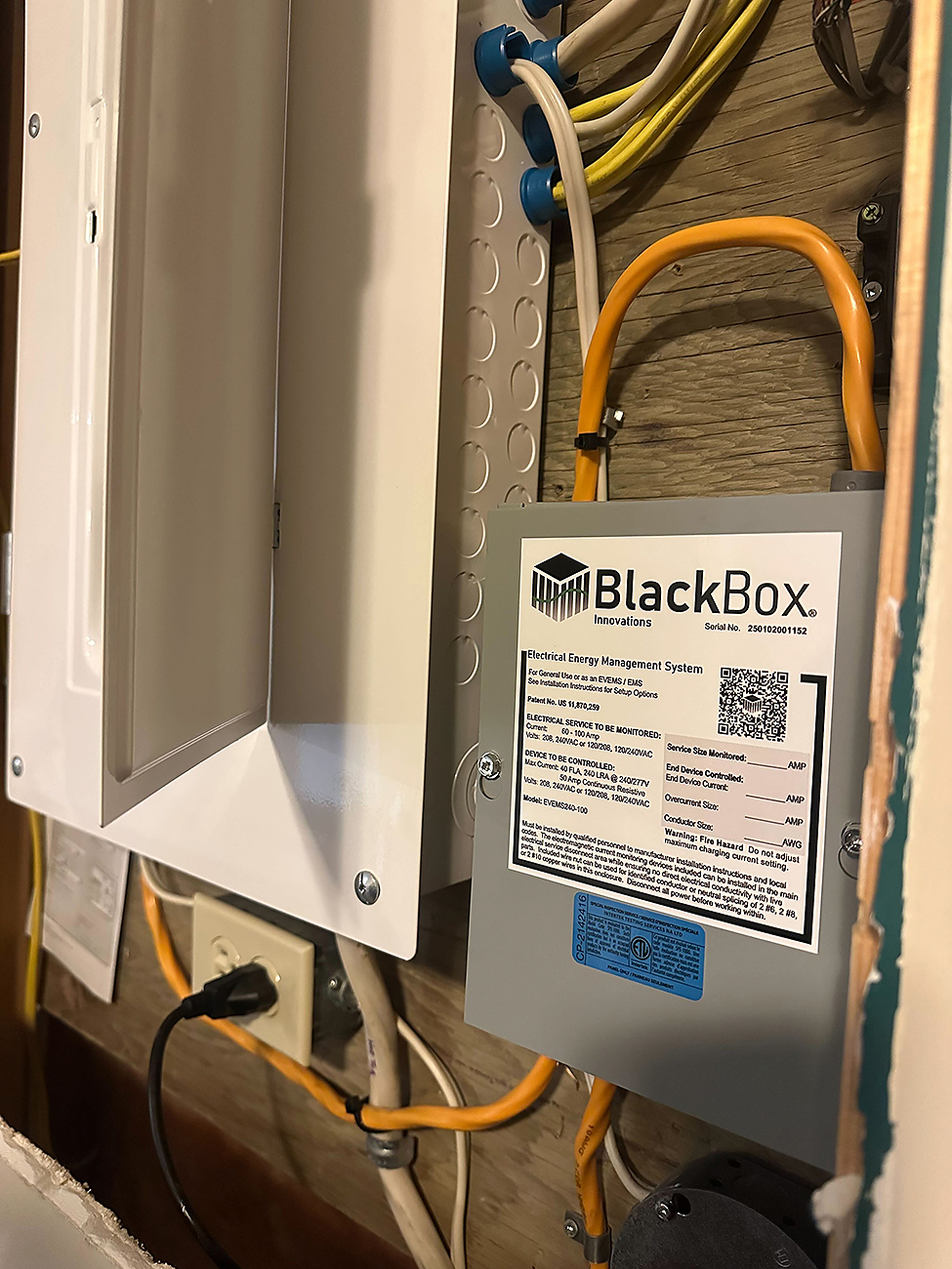 Load Shedding Device Installation in Calgary | Crew Technical Services Electrician installing a load shedding device on a Calgary electrical panel for improved home safety.