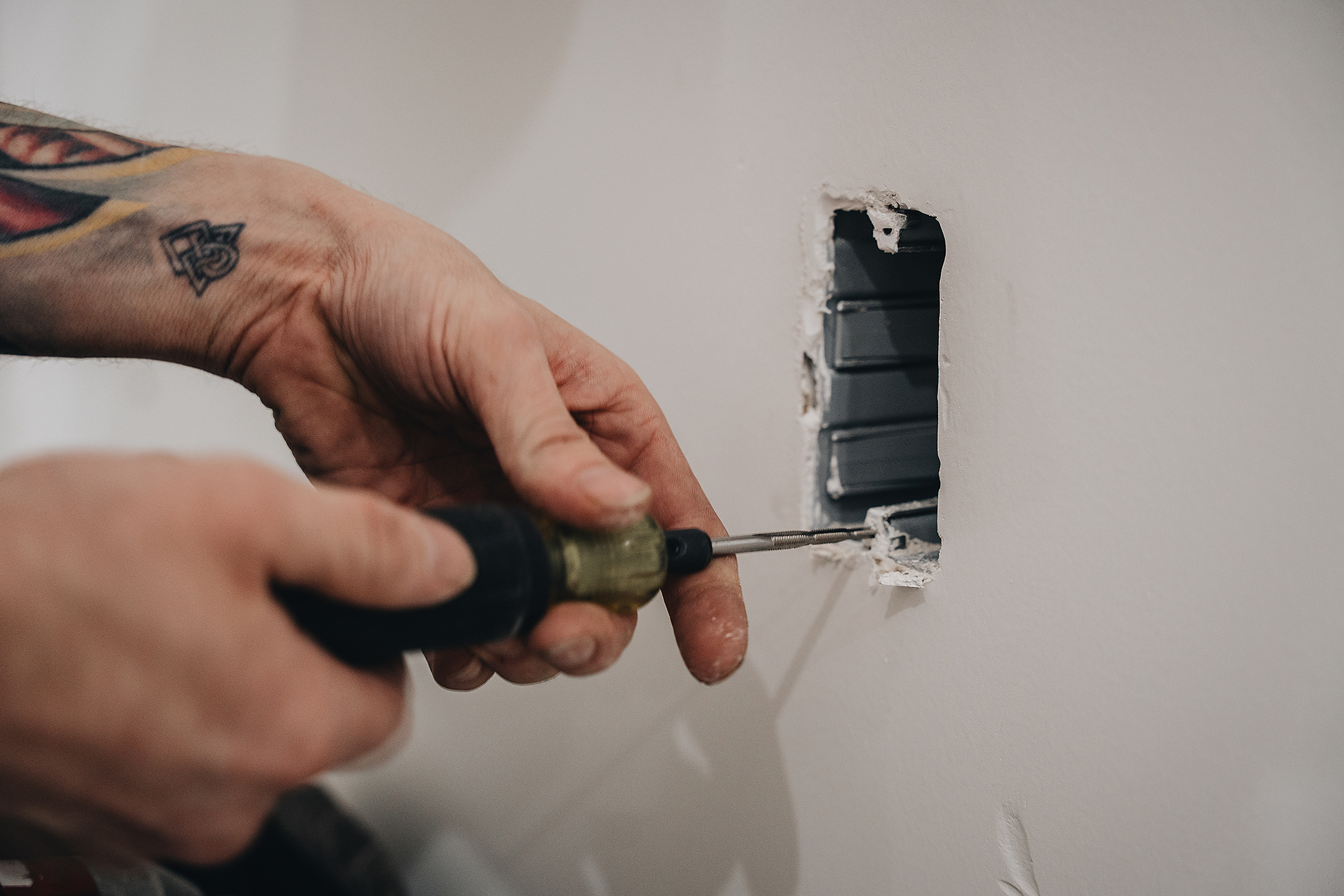 Crew Technical Services troubleshooting an outlet in a Calgary home