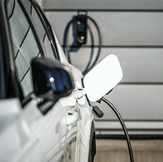 Crew Technical Services electrician installing a home EV charger in a Calgary garage