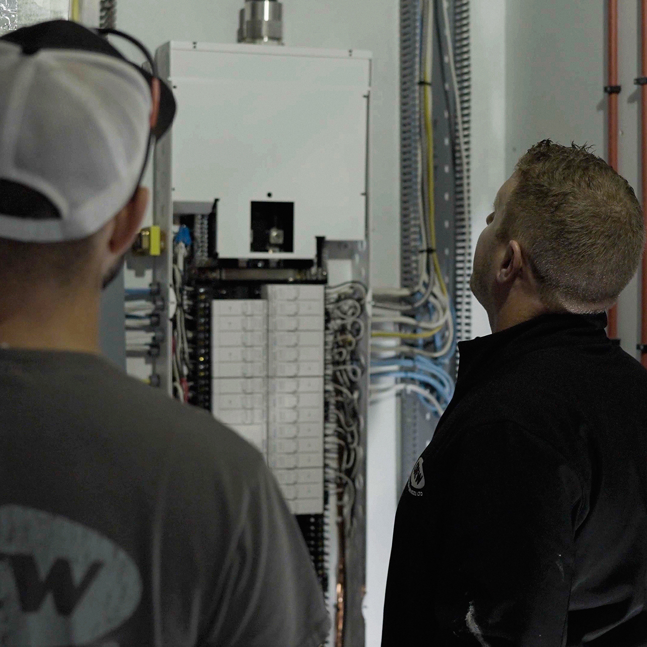 Crew Technical Services electrician installing an upgraded electrical panel in a Calgary home
