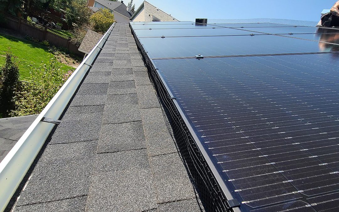 Electrician connecting a solar array to a home electrical panel in Calgary